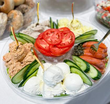 A continental platter of bagels, tuna and egg salad, whitefish, cream cheese, smoked salmon, capers, cucumber and tomato