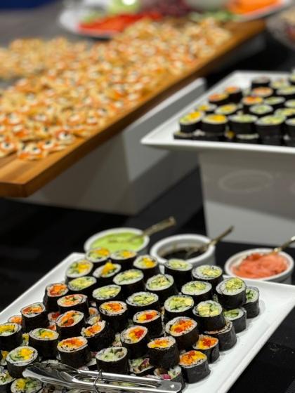 Platters of vegetarian maki rolls and bite-sized canapés at a catered reception
